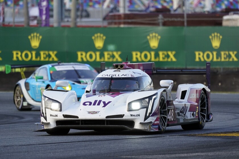 FILE - Jimmie Johnson drives the Cadillac Dpi during the Rolex 24 hour auto race at Daytona International Speedway, Saturday, Jan. 30, 2021, in Daytona Beach, Fla. Johnson is part of the No. 48 Cadillac team that will compete in the race beginning Jan. 29, 2022. (AP Photo/John Raoux, File)