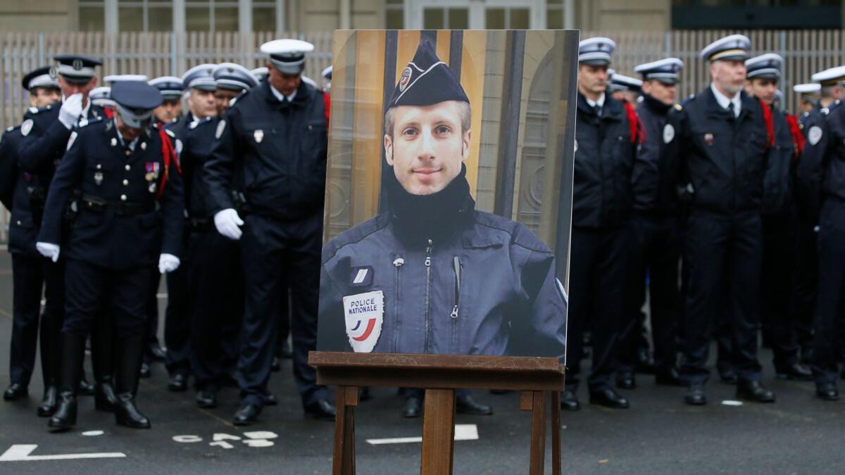 A portrait of slain police officer Xavier Jugele in the courtyard of the Paris Police headquarters before a ceremony Tuesday.