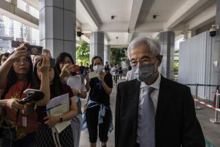 Martin Lee, right, the founding chairman of the city’s Democratic Party, leaves high court after a ruling on a challenge that he and six other activists had filed against their conviction on charges of organizing and taking part in an unauthorized assembly in Hong Kong, Monday, Aug. 14, 2023. (AP Photo/Louise Delmotte)