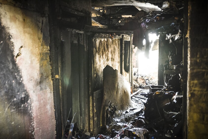 Debris litters the inside of a warehouse where a fire killed 36 people during a club-style party.