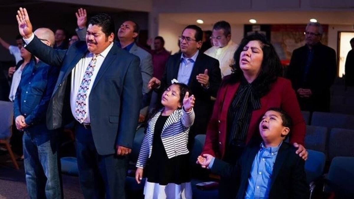 Pastor Noe Carias with wife, Victoria, and their children Nylah and Abraham at their East L.A. church in April