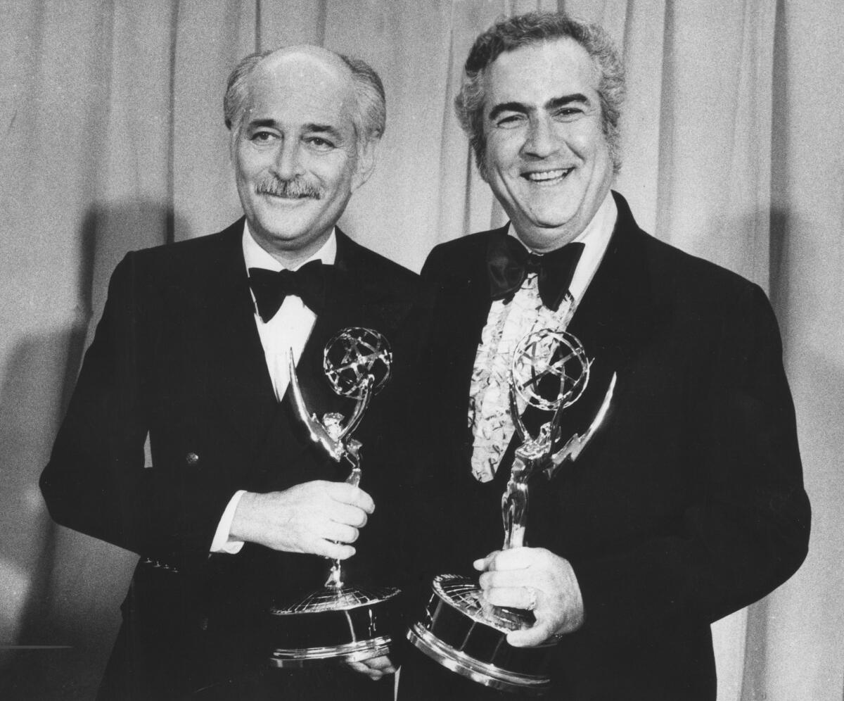 Norman Lear and John Rich holding their Emmys for outstanding comedy series for "All in the Family" in 1973