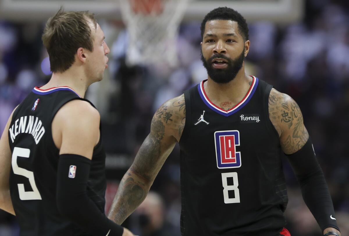 Marcus Morris Sr. and Luke Kennard pause during a Clippers game in 2022.