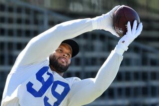 Rams defensive lineman Aaron Donald catches a ball during training camp.