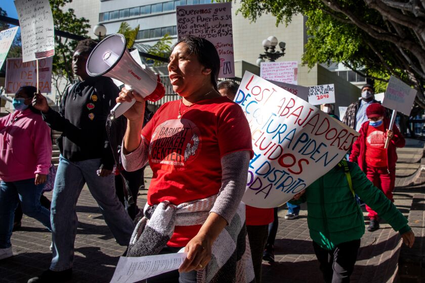 LOS ANGELES, CA - APRIL 04: The Protect LA's Garment Jobs Coalition, along with garment workers and labor and affordable-housing allies, pushing for changes to the DTLA 2040 Community Plan rally outside City Hall on Tuesday, April 4, 2023 in Los Angeles, CA. (Irfan Khan / Los Angeles Times)