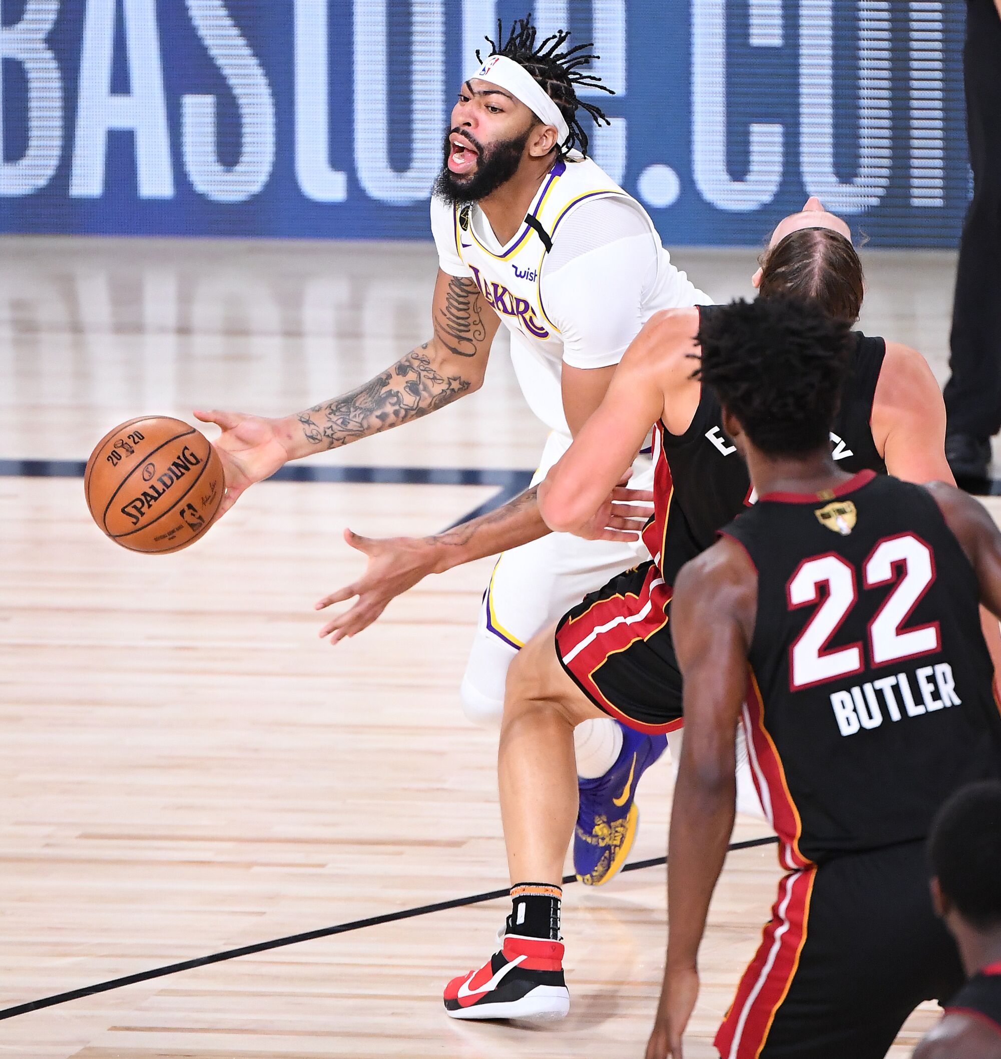 Lakers forward Anthony Davis commits a foul by charging into Heat center Kelly Olynyk during Game 3.