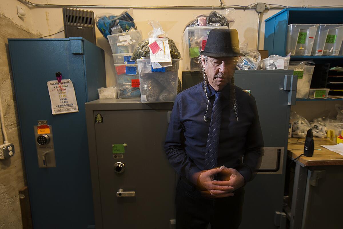 Steve DeAngelo, the co-founder and executive director of Harborside Health Center in Oakland, stands in the room where the medical marijuana dispensary's cash reserves are kept. He does not believe he will have a problem getting a state license despite a felony in his background.