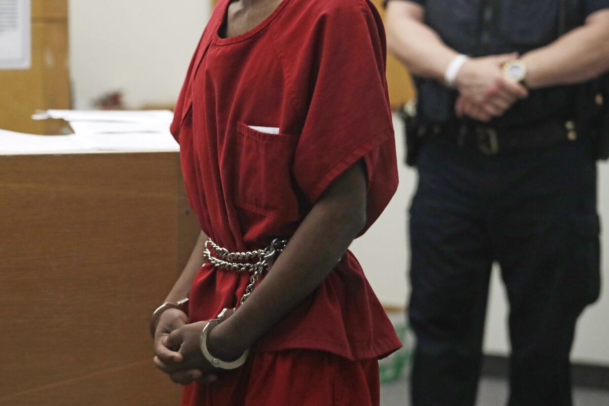Dawit Kelete wears handcuffs