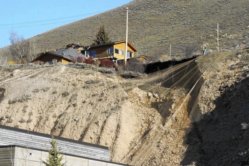 A damaged home sits atop a slow-moving landslide on East Gros Ventre Butte in Jackson, Wyo.