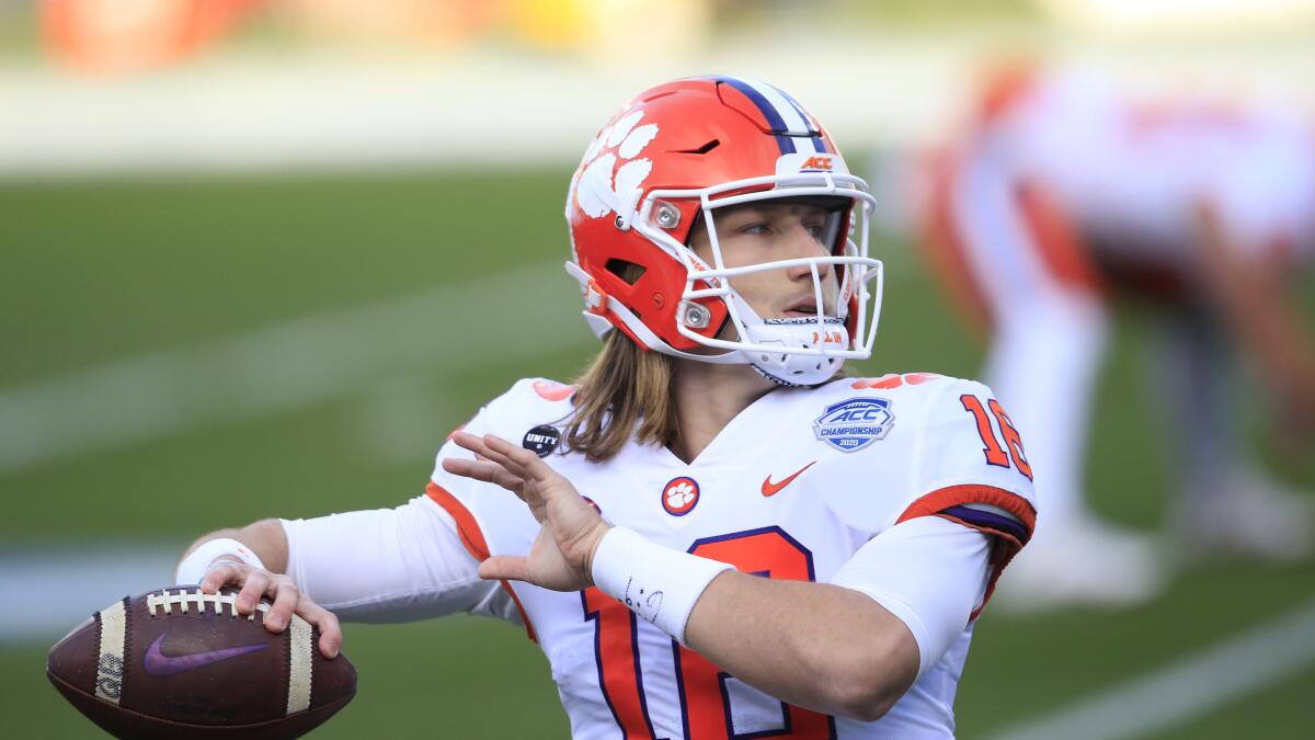 Clemson quarterback Trevor Lawrence winds up for a pass as he looks downfield.