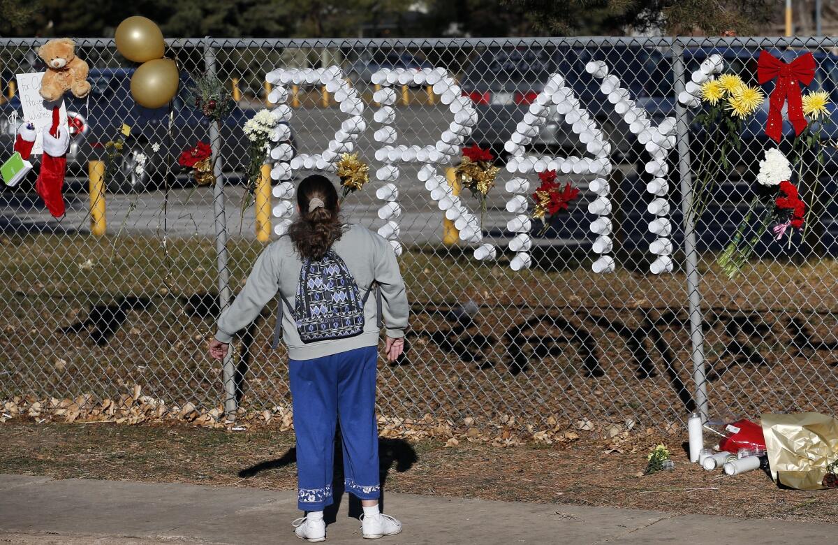 A makeshift memorial continues to attract visitors at Arapahoe High School in Centennial, Colo., after a Dec. 13 shooting. Now two teens have been arrested in an alleged plot to shoot up their high school in Trinidad, Colo.