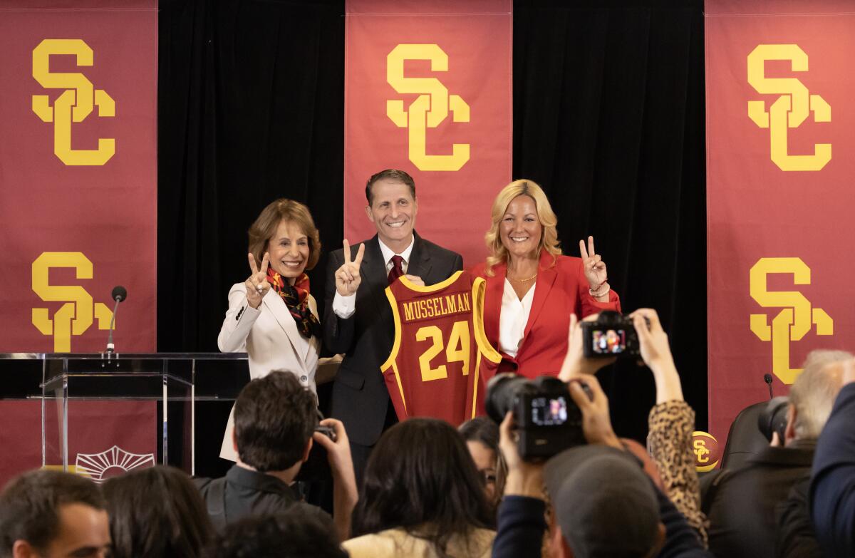 Eric Musselman stands between USC President Carol Folt, left, and athletic director Jennifer Cohen.