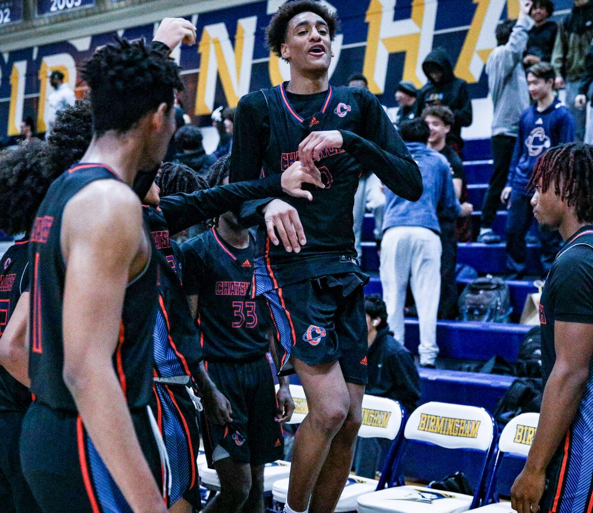 Alijah Arenas of Chatsworth celebrates after making a three-point shot.
