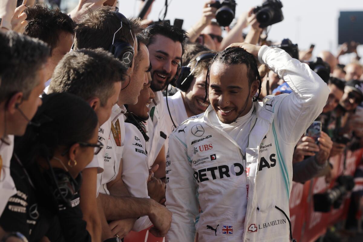 Lewis Hamilton is congratulated by his teammates after the U.S. Grand Prix. 