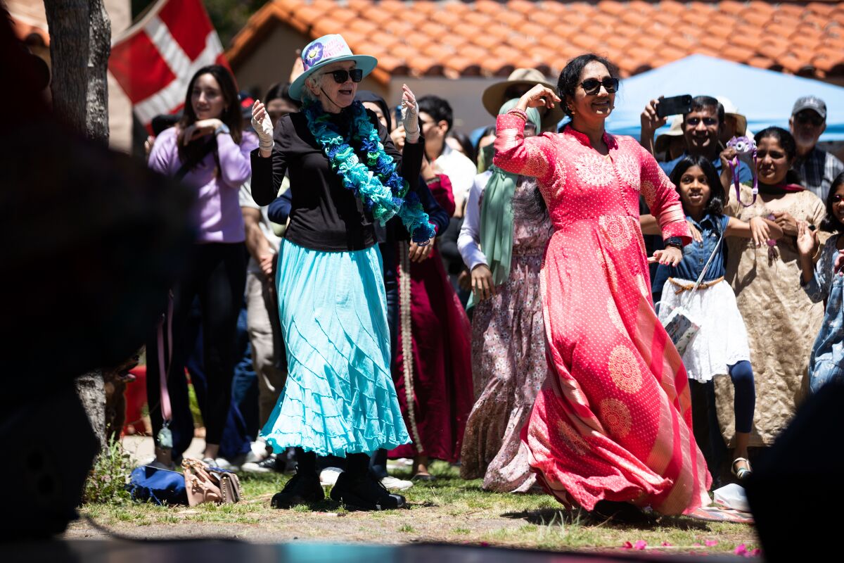 Alice Breakstalker, 78, and Ratna Vatrap, 54, dance to Indian dances at the 40th Annual Ethnic Food Fair. 