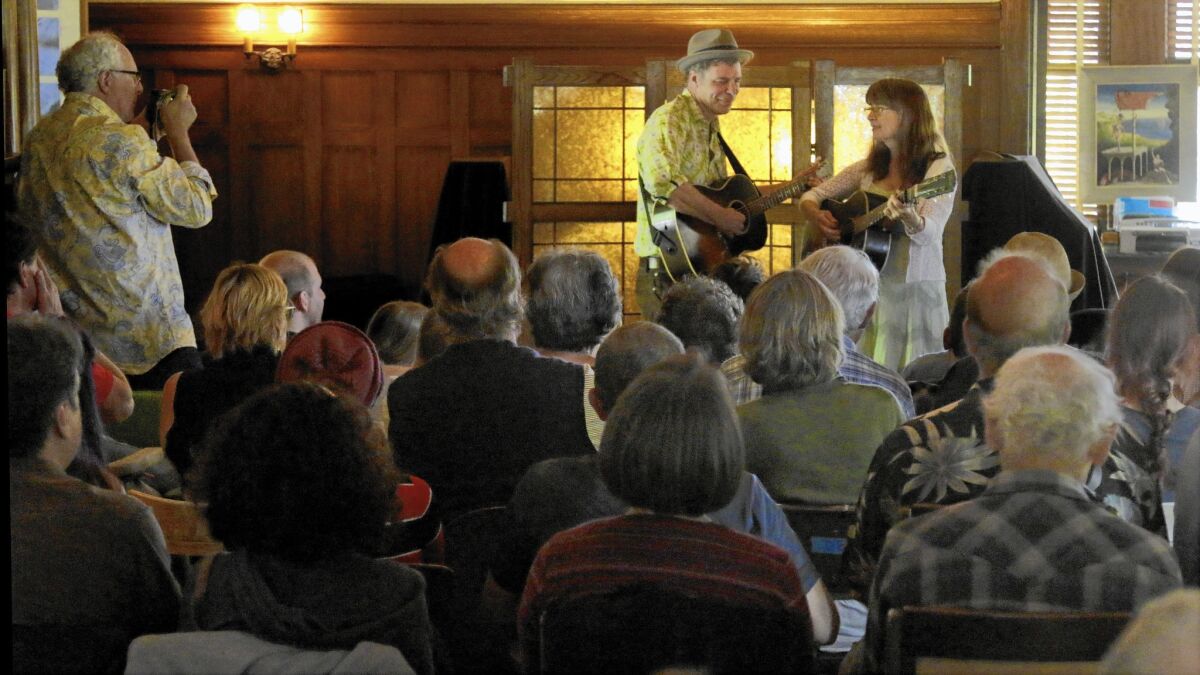 Musicians John Grimm and Beverly Smith perform before an audience in the living room at David Bunn's farmhouse in the Santa Paula area on May 24, 2015.