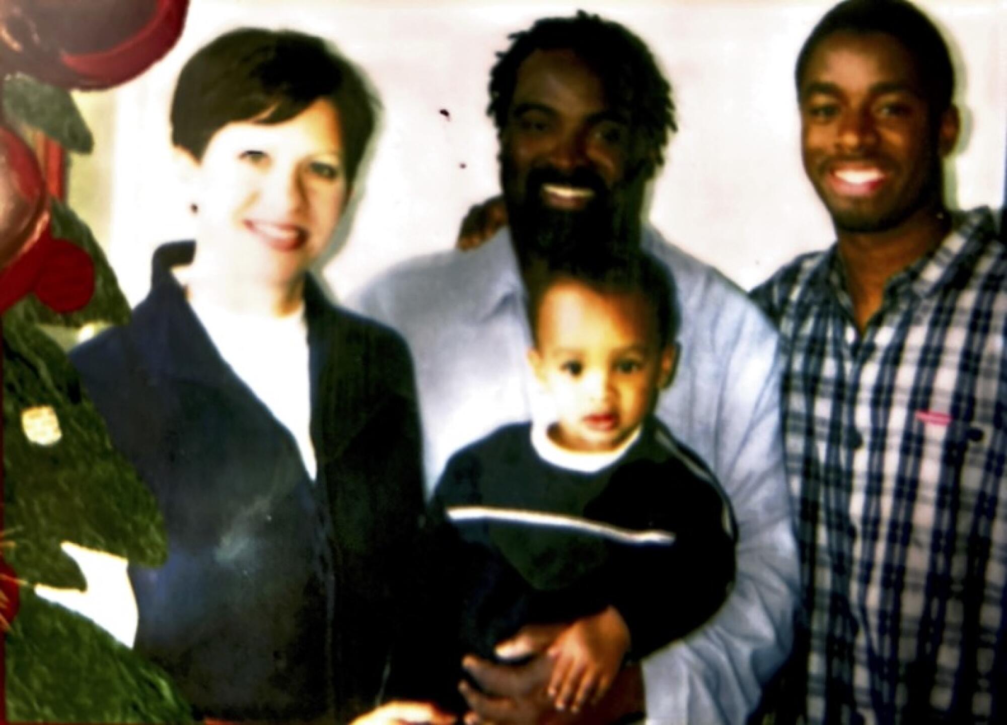 Stanley Wilson Jr., right, with Stanley Wilson Sr., center, and his father's wife Kimberly, and their son Seth.