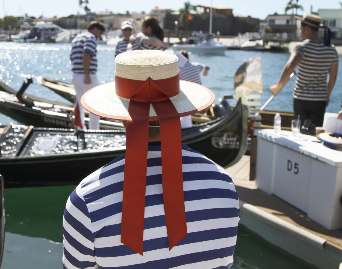 A competitor in the U.S. Gondola Nationals wears the traditional gondolier's straw hat and red ribbon with blue-and-white-striped shirt.