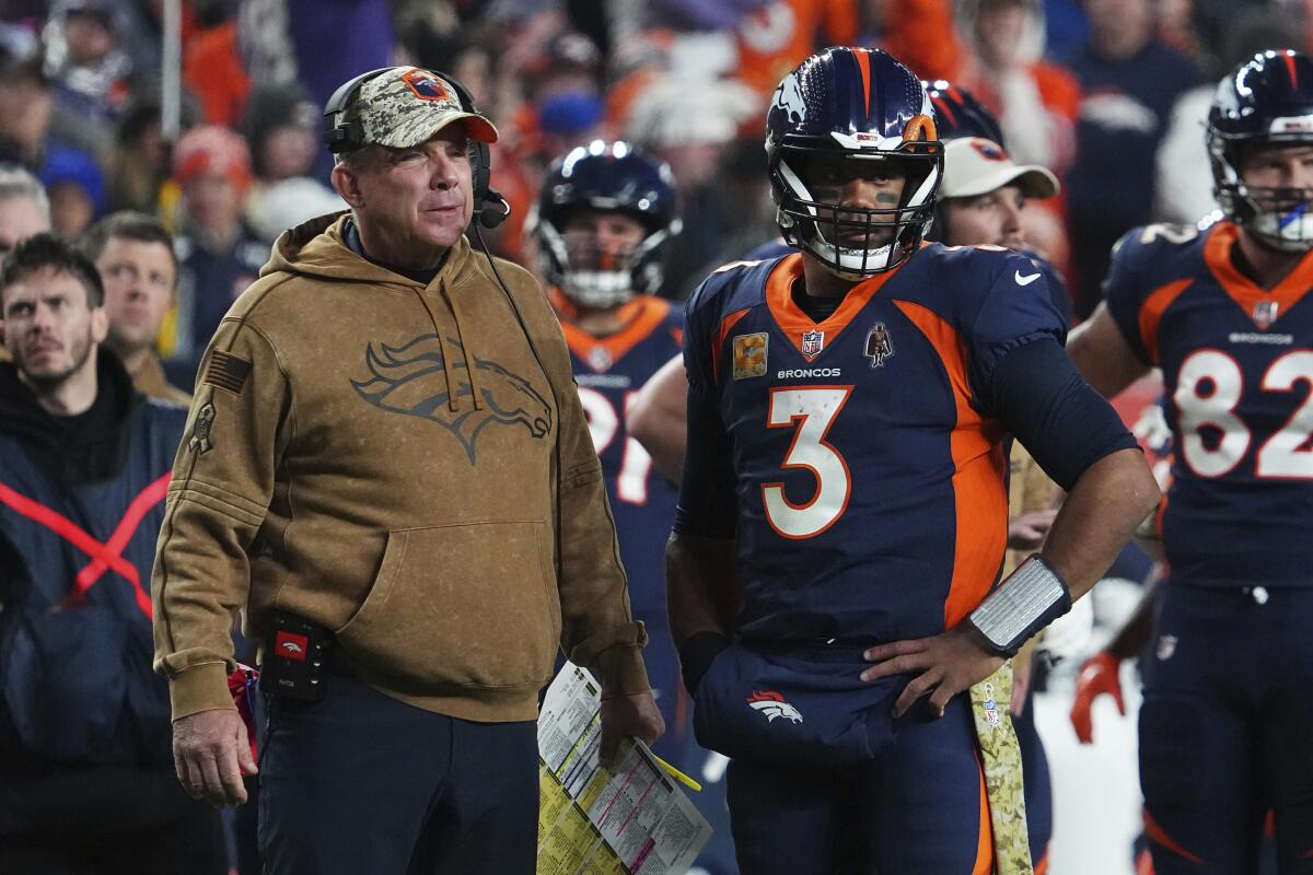 Denver Broncos coach Sean Payton and quarterback Russell Wilson (3) talk during a timeout.