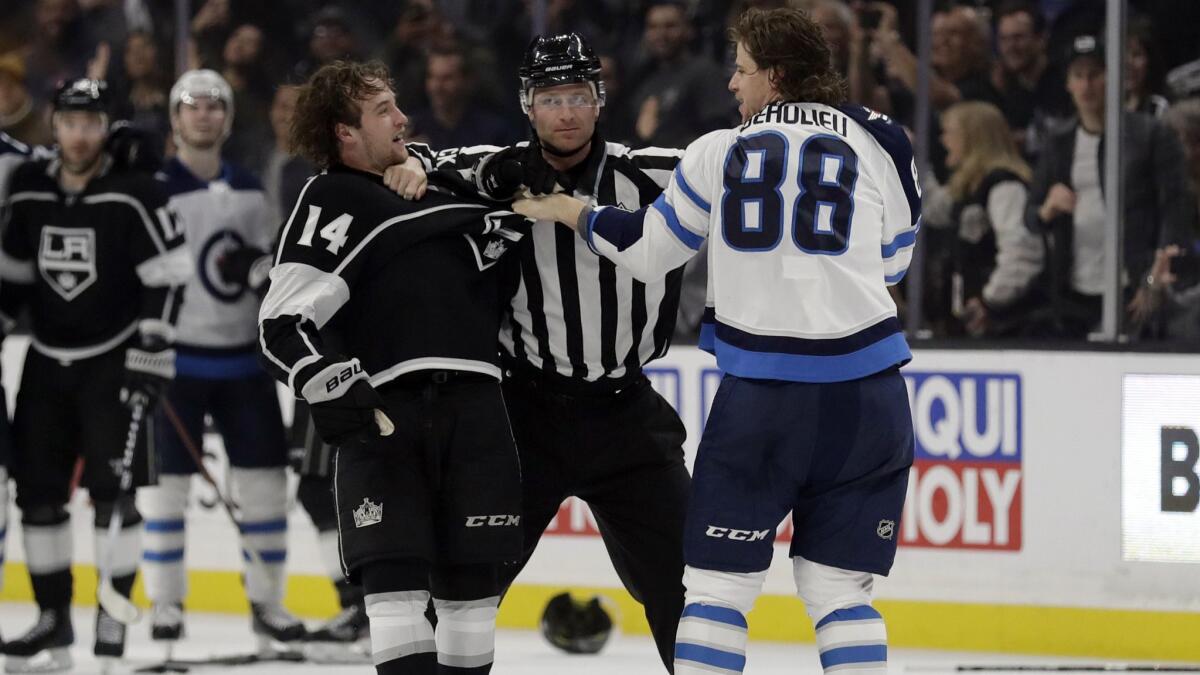 Kings' Brendan Leipsic, left, and Winnipeg Jets' Nathan Beaulieu (88) are separated by a referee during the second period.