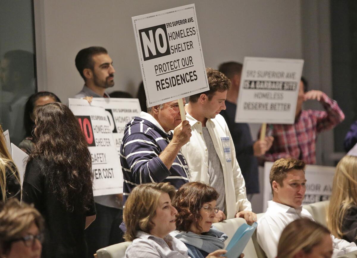 Residents picket at a Newport Beach City Council meeting in October to voice their disapproval of a homeless shelter proposed for Superior Avenue.