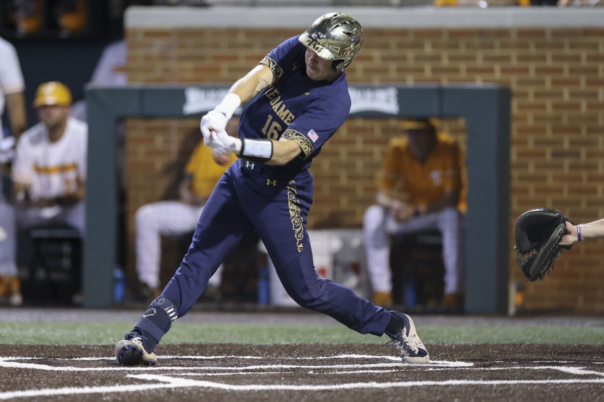 Notre Dame's Jared Miller singles against Tennessee in the ninth inning during an NCAA college baseball super regional game Friday, June 10, 2022, in Knoxville, Tenn. (AP Photo/Randy Sartin)