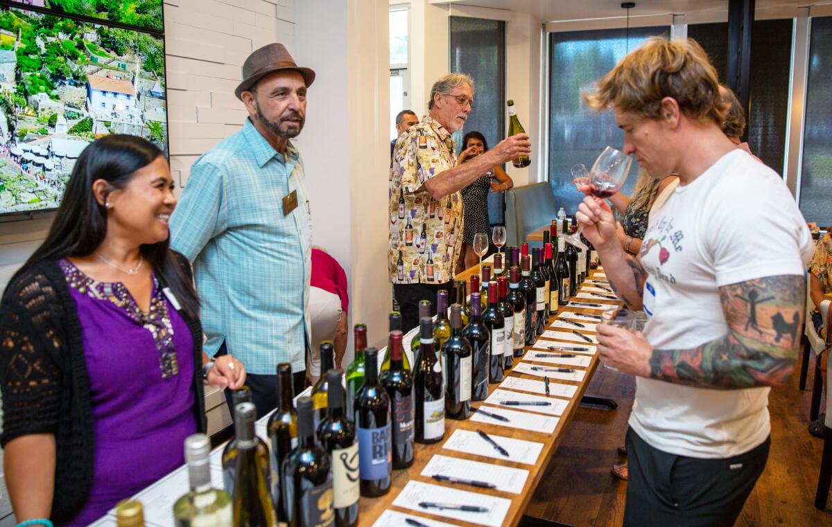 Janice Roussel, Atta Erikas and Brian Jackson at the 2022 "Wine-down Summer" fundraiser in Pacific Beach.