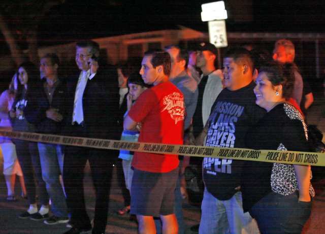 A crowd watches the aftermath of a plane crash in North Glendale