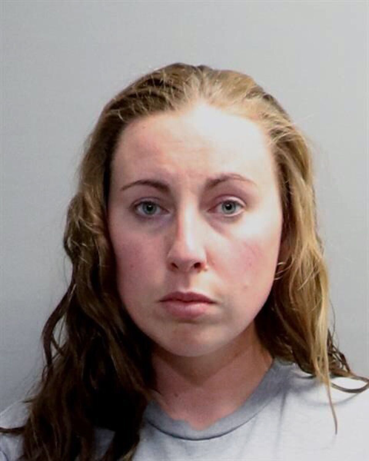 A photo provided by the Oakland County Sheriff's Office shows Jillian Wuestenberg. Wuestenberg and her husband, Eric Wuestenberg, were arrested after at least one handgun was pulled on a Black woman and her daughters during a videotaped confrontation in a restaurant parking lot in Orion Township, Mich., authorities said Thursday, July 2, 2020. The two were charged Thursday with felonious assault, Oakland County Prosecutor Jessica Cooper said in a release. (Oakland County Sheriff's Office via AP)