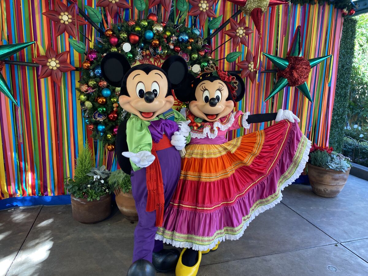 The “Disney ¡Viva Navidad!” street party features Mickey and Minnie dressed for the occasion at Disneyland in Anaheim.
