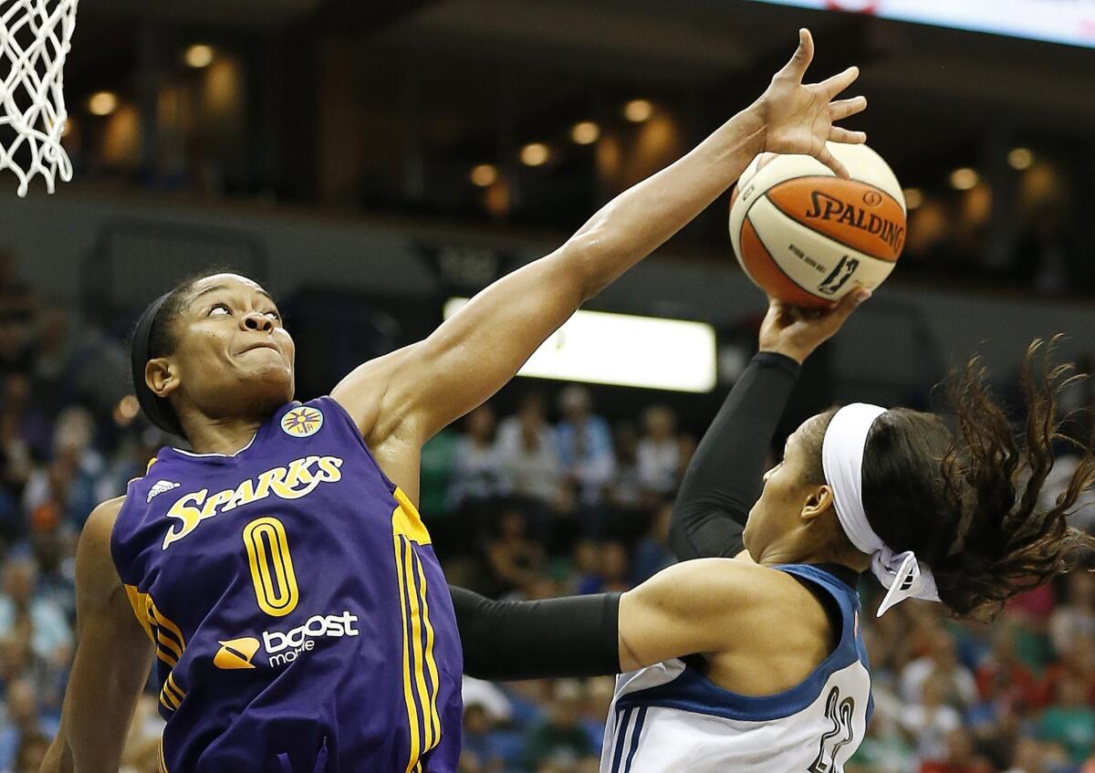 Sparks guard Alana Beard tries to block the shot of Minnesota's Maya Moore during a game on Aug. 12.