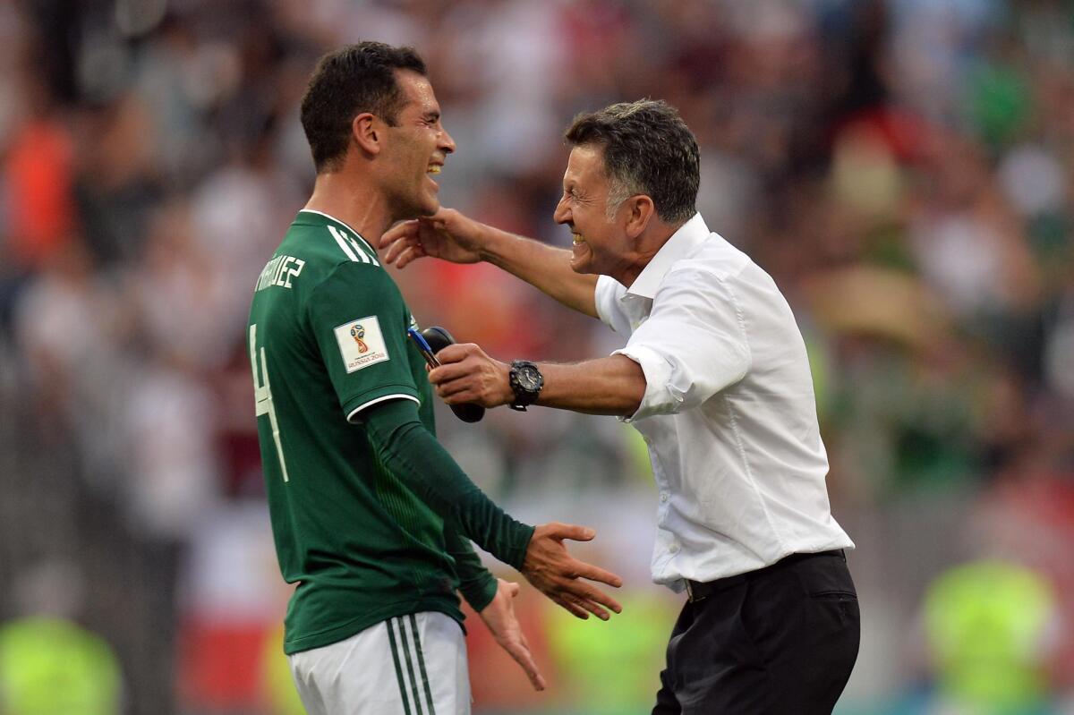 Mexico's coach Juan Carlos Osorio (R) reacts with Rafael Marquez of Mexico after winning the FIFA World Cup 2018 group F preliminary round soccer match between Germany and Mexico in Moscow, Russia, 17 June 2018.