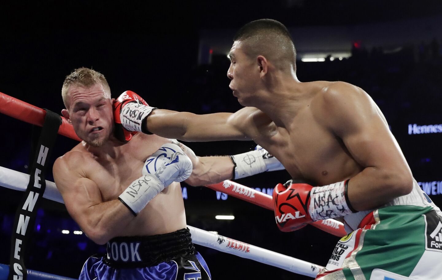 Jaime Munguia, right, punches Brandon Cook during their WBO junior middleweight championship boxing match, Saturday, Sept. 15, 2018, in Las Vegas. Munguia won by TKO.