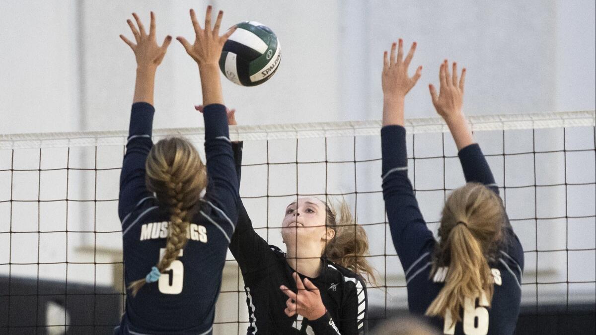 Sage Hill School's Danielle Beder hits against Trabuco Hills' Kendall Anselmo, left, and Shannon Spencer during a nonleague girls' volleyball match on Tuesday.