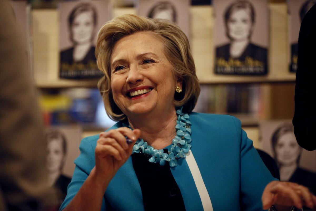 Hillary Rodham Clinton signs her book "Hard Choices" at the Common Good Books store in St. Paul, Minn., on July 20, 2014.