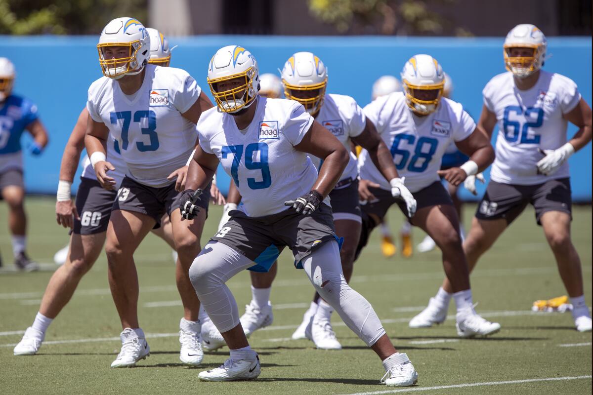 Chargers offensive tackle Trey Pipkins III (79) takes part in practice drills in June.