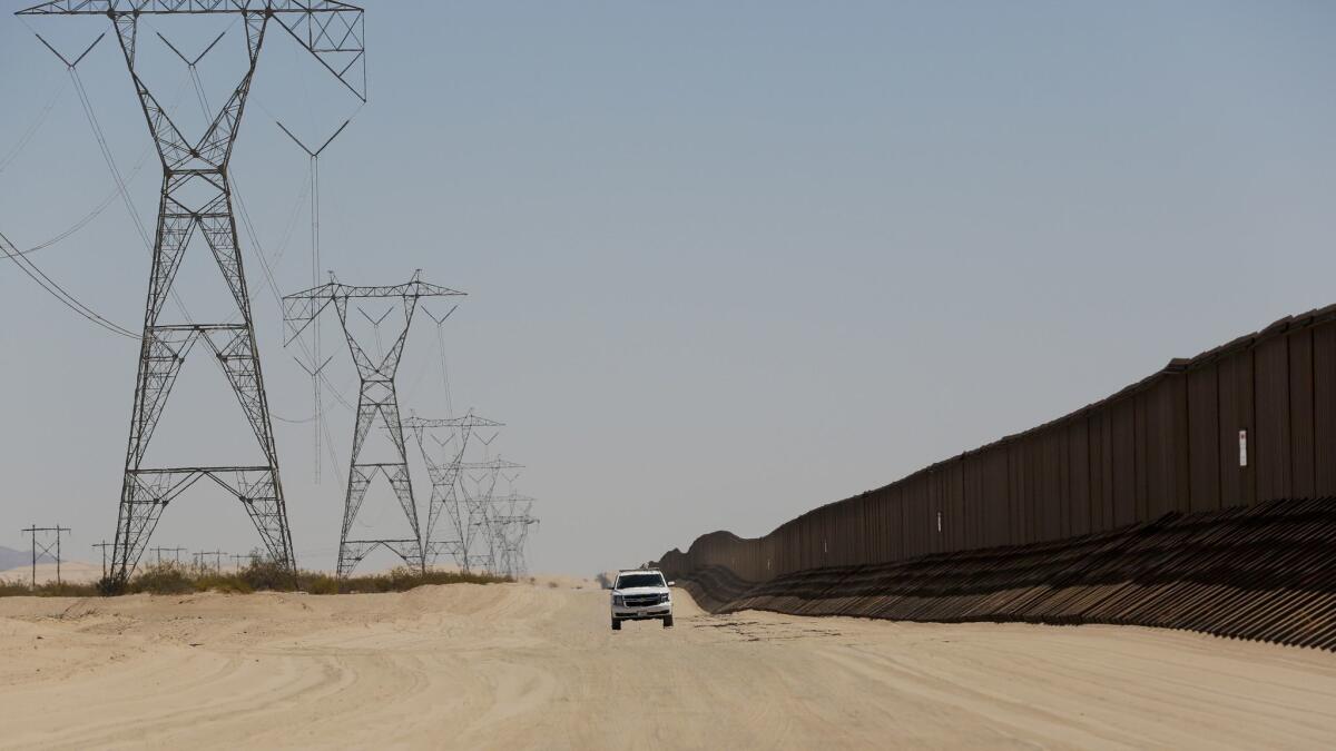 A Border Patrol agent drives along the "floating fence" between Calexico, Calif. and Yuma, Ariz. Operation Blazing Sands began in August to prevent human smuggling along a 20-mile stretch of border between Calexico and Yuma.