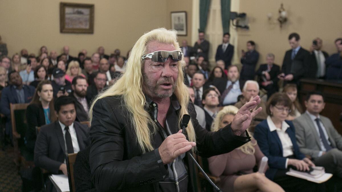 Reality TV personality Duane "Dog the Bounty Hunter" Chapman urges California lawmakers to reject a measure to change the state's bail system during an Assembly hearing in 2017.