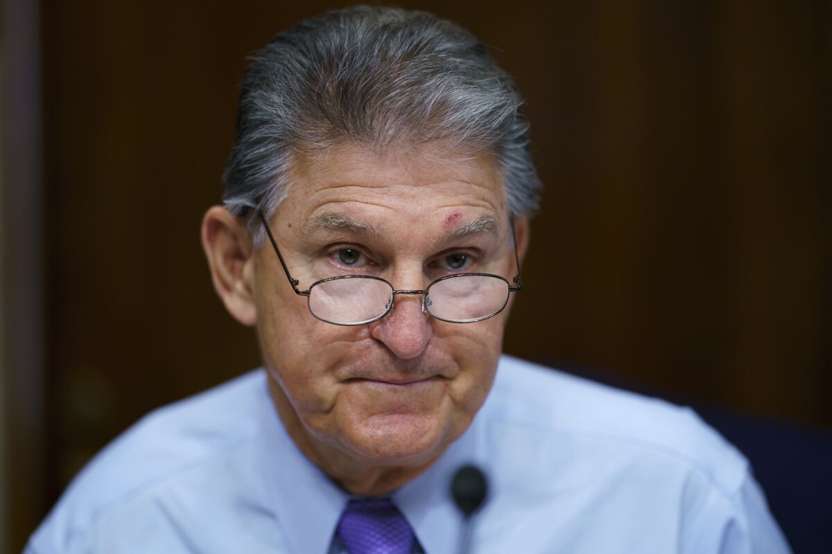FILE - In this Aug. 5, 2021, file photo Sen. Joe Manchin, D-W.Va., prepares to chair a hearing in the Senate Energy and Natural Resources Committee, as lawmakers work to advance the $1 trillion bipartisan bill, at the Capitol in Washington. Manchin said Thursday, Sept. 2, that Congress should take a “strategic pause” on more spending, warning that he does not support President Joe Biden's plans for a sweeping $3.5 trillion effort to rebuild and reshape the economy. (AP Photo/J. Scott Applewhite, File)
