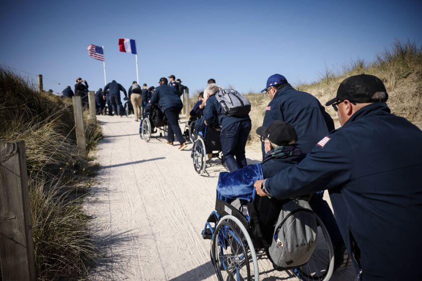 U.S. veterans arrive for the commemoration organized by the Best Defense Foundation at Utah Beach near Sainte-Marie-du-Mont, Normandy, France, Sunday, June 4, 2023, ahead of the D-Day Anniversary. The landings on the coast of Normandy 79 year ago by U.S. and British troops took place on June 6, 1944. (AP Photo/Thomas Padilla)