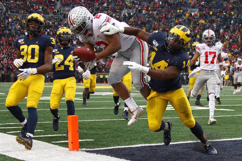 ANN ARBOR, MICHIGAN - NOVEMBER 30: J.K. Dobbins #2 of the Ohio State Buckeyes dives for a fourth quarter touchdown past Josh Metellus #14 of the Michigan Wolverines at Michigan Stadium on November 30, 2019 in Ann Arbor, Michigan. (Photo by Gregory Shamus/Getty Images)