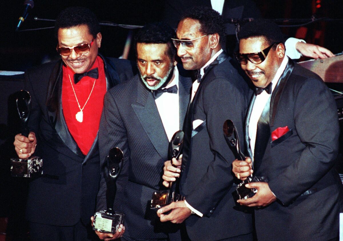 FILE - The Four Tops, from left, Renaldo "Obie" Benson, Levi Stubbs Abdul "Duke" Fakir, and Lawrence Payton hold their awards after being inducted into the Rock and Roll Hall of Fame in New York on Jan. 17, 1990. Fakir wrote a memoir, "I'll Be There: My Life With The Four Tops." (AP Photo/Ron Frehm, File)
