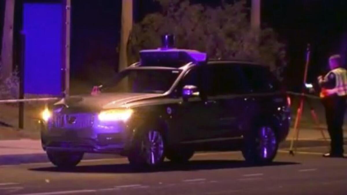 An investigator at the scene of a fatal accident involving a self-driving Uber vehicle in Tempe, Ariz.