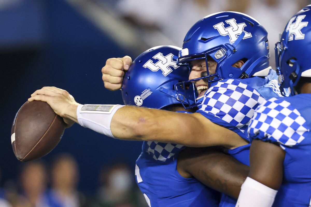 Kentucky quarterback Will Levis, right, hugs running back Chris Rodriguez Jr. (left) after winning an NCAA college football game against Florida in Lexington, Ky., Saturday, Oct. 2, 2021. (AP Photo/Michael Clubb)