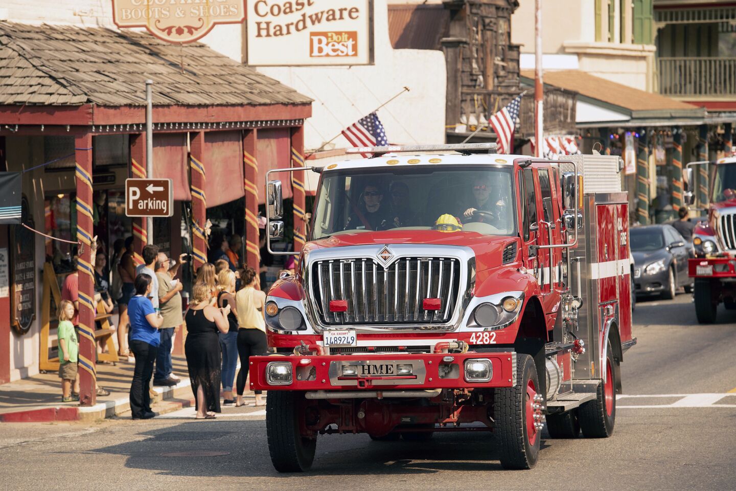 A procession of firetrucks carrying the body of firefighter Braden Varney makes its way along Highway 140 in Mariposa.