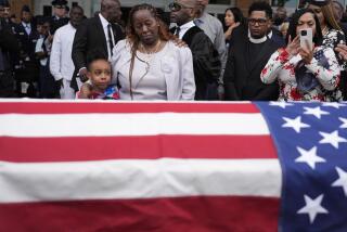 Chantemekki Fortson the mother of slain airman Roger Fortson, right, along with family watch Fortson's casket as they leave for a cemetery during his funeral at New Birth Missionary Baptist Church, Friday, May 17, 2024, in Stonecrest, Ga. (AP Photo/Brynn Anderson)