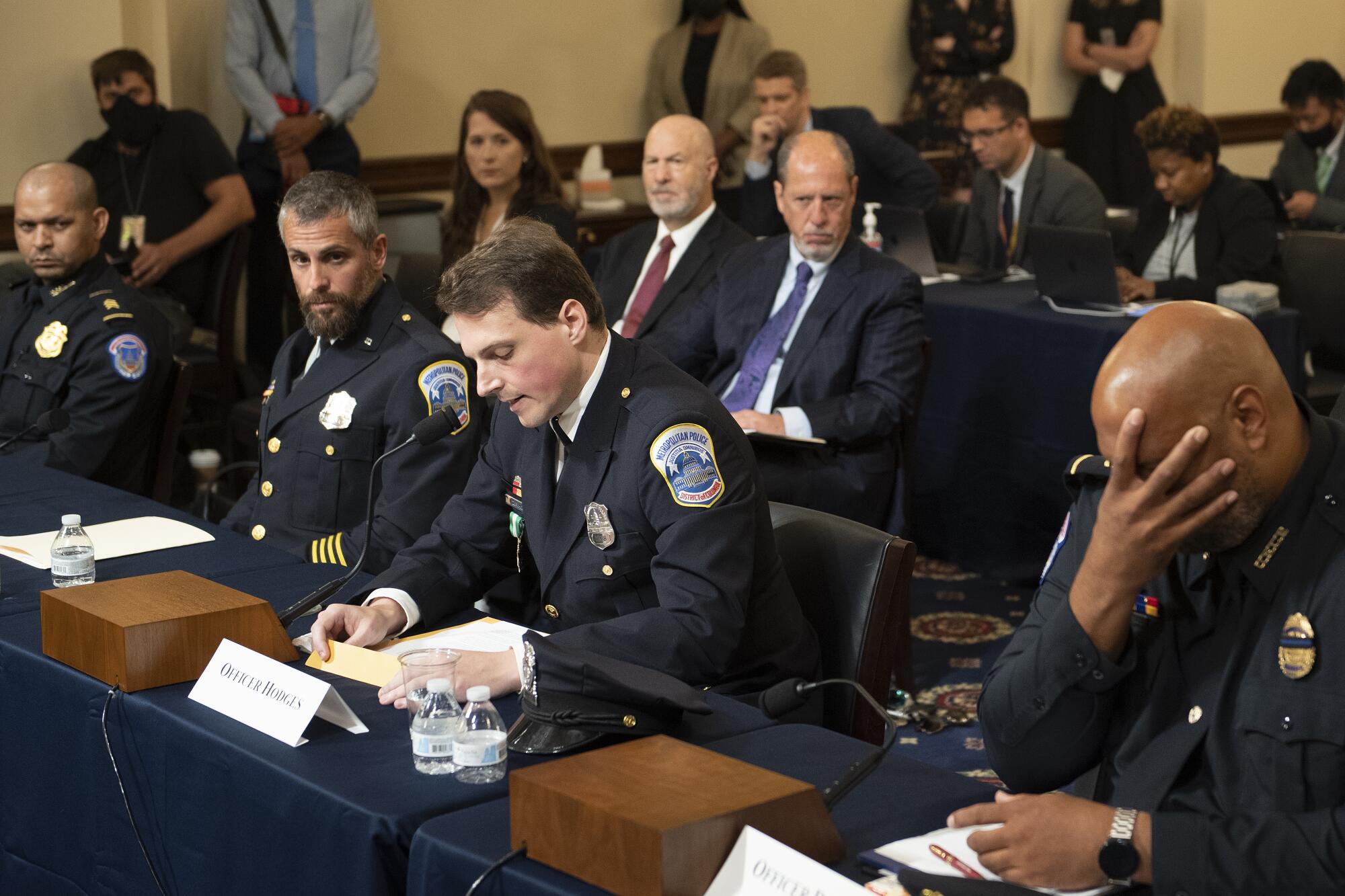 Officers listen to testimony.