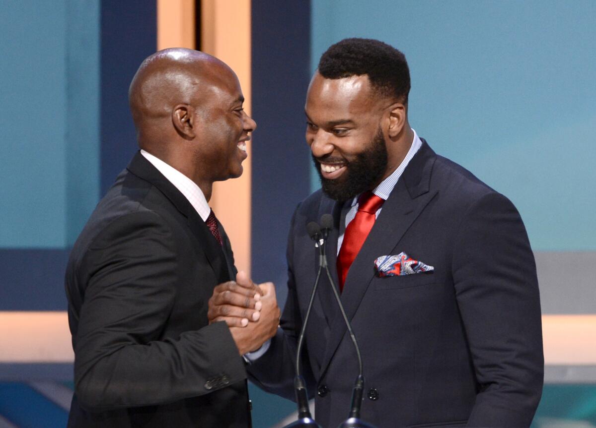A bearded Baron Davis is greeted by host Kevin Frazier during the 28th Anniversary Sports Spectacular Gala.
