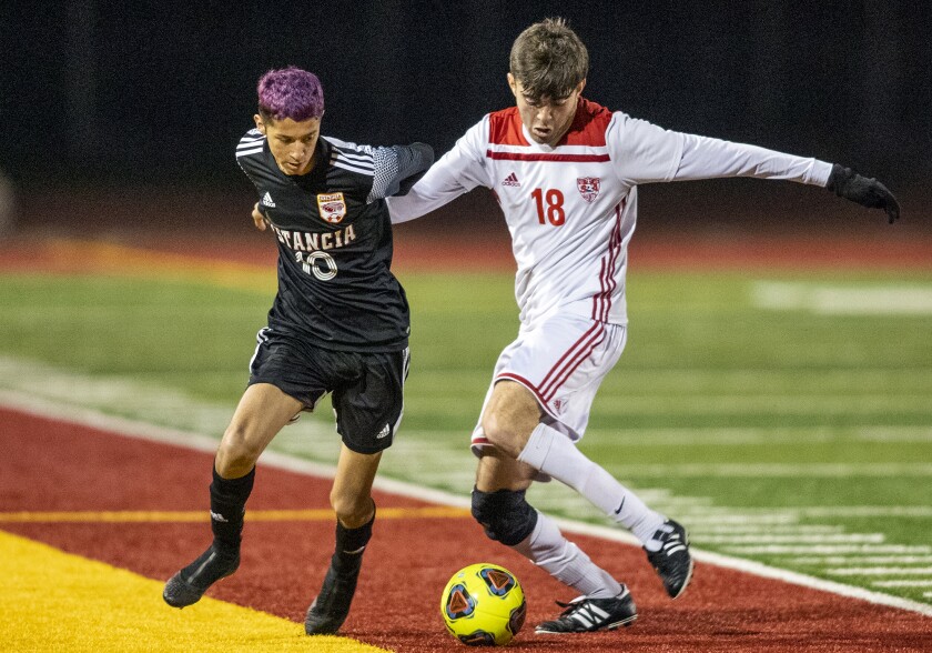 Estancia's Felix Solis and Santa Ana's Mateo Moreno battle for a ball on Friday.