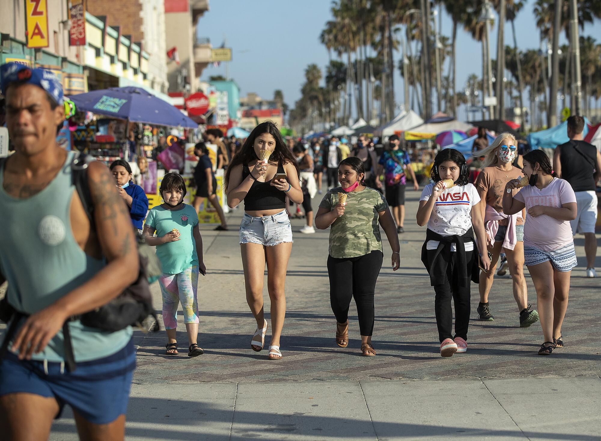 People fill Venice Beach boardwalk.